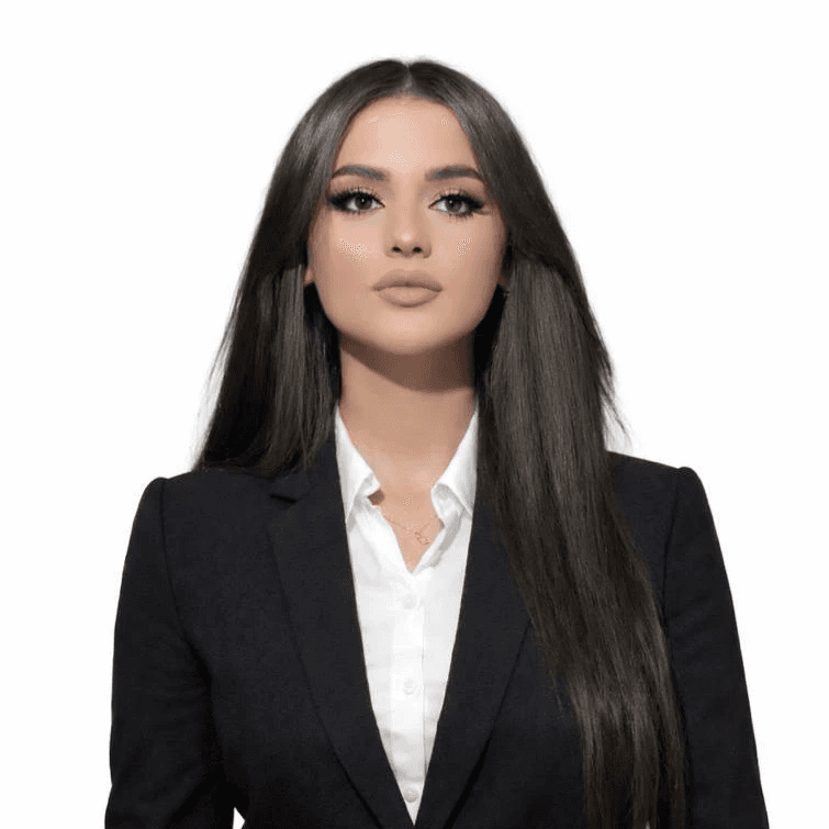 a woman with long brown hair smiling at the camera