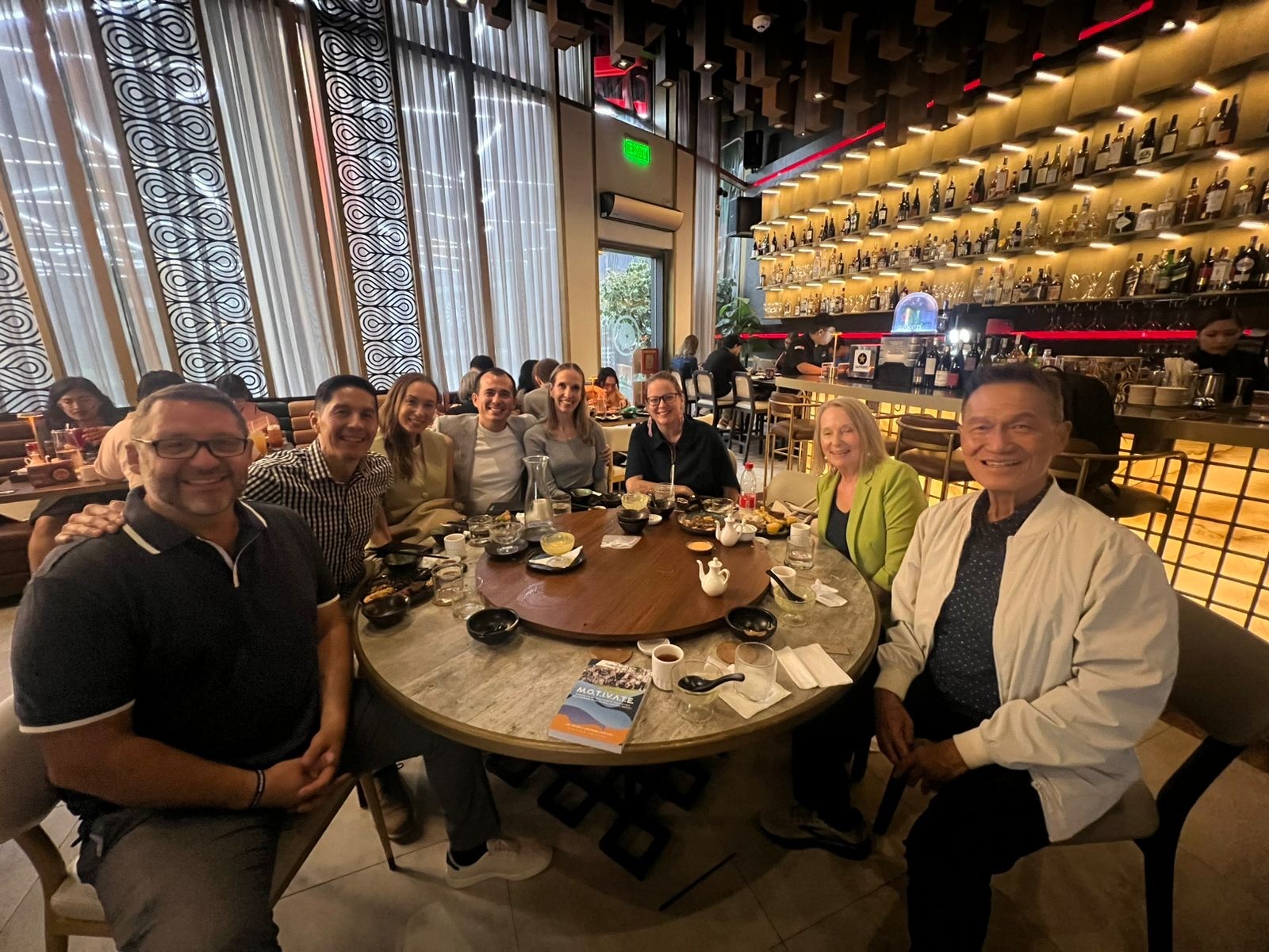 A picture of a group of people around a table