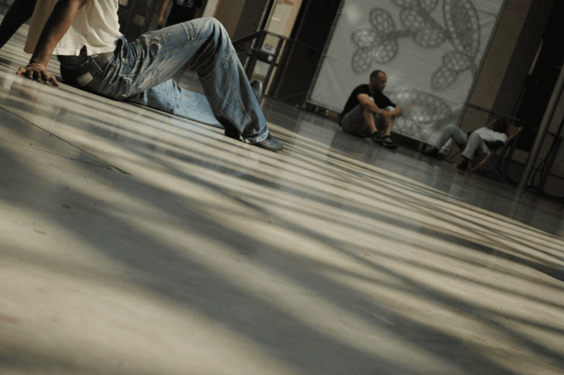 Amateur breakdancers sit before practicing.