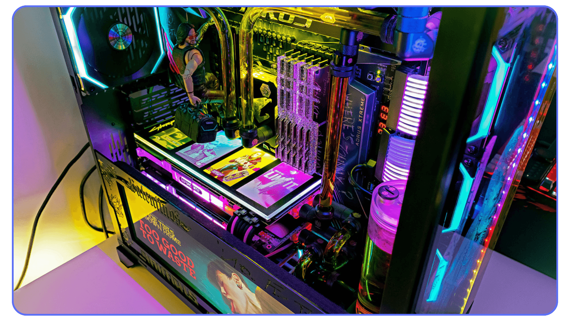 A close-up of a custom-built PC with vibrant RGB lighting, featuring a water cooling system, glowing memory modules, and a small action figure inside the case.