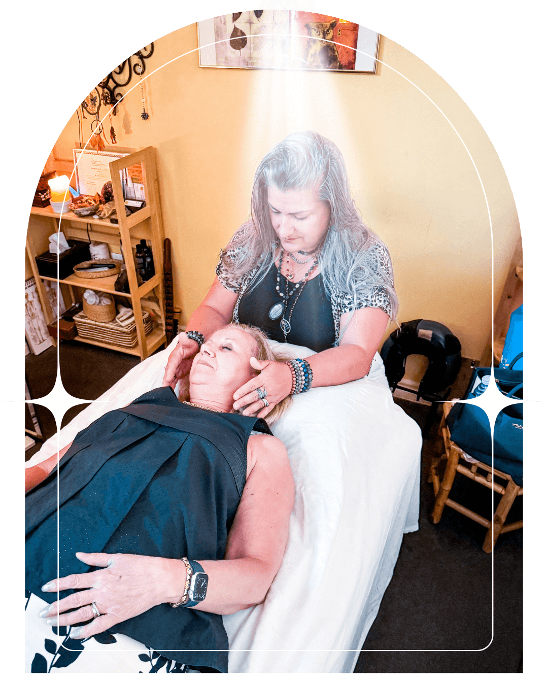 A woman sits cross-legged with eyes closed, wearing a white blouse and a long purple skirt, looking serene.