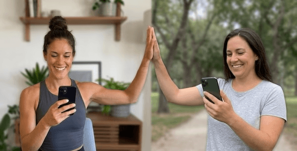 person taking picture of two teacups