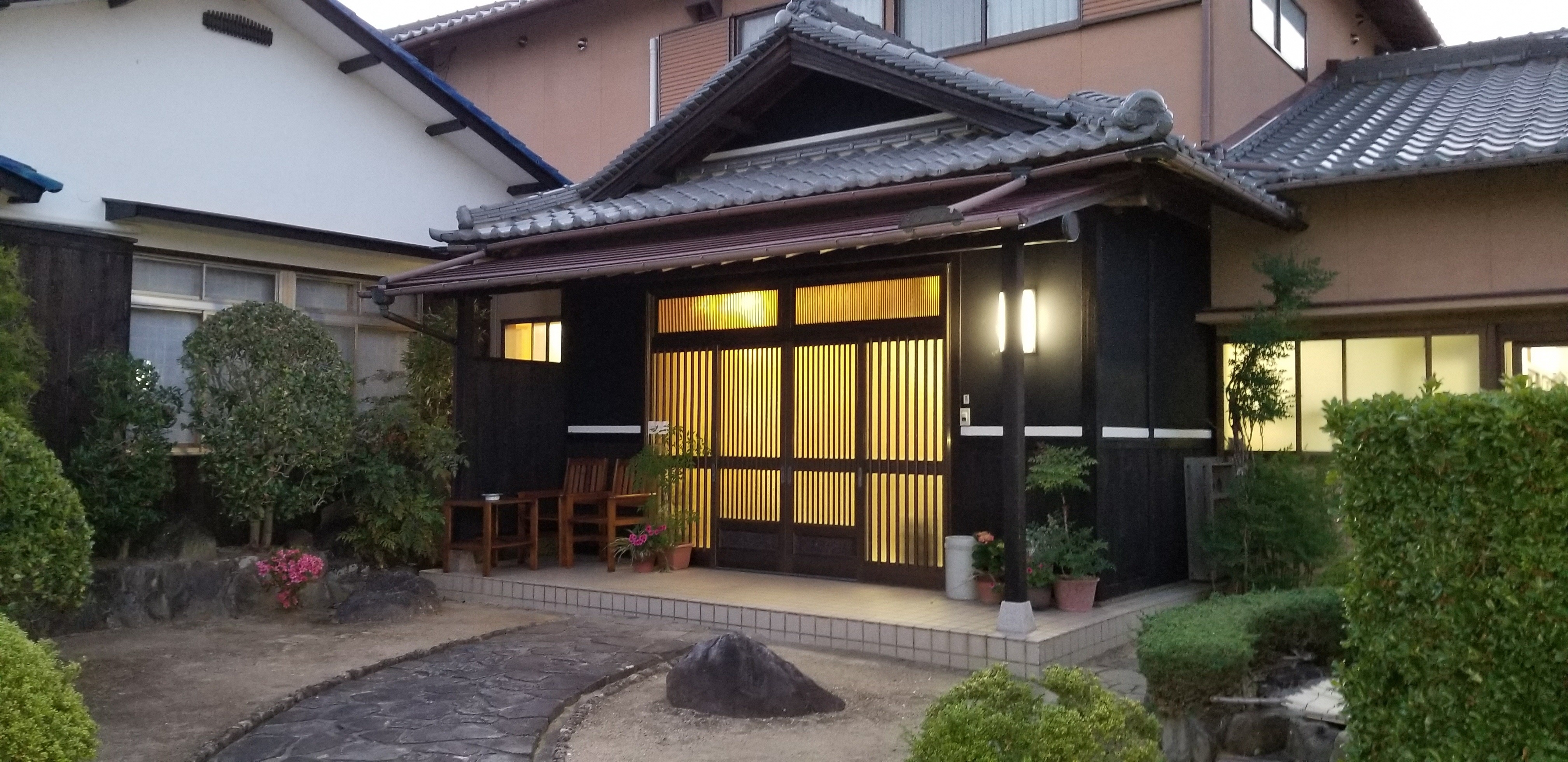Exterior shot of the hotel and it's traditional Japanese architecture with dark brown walls
