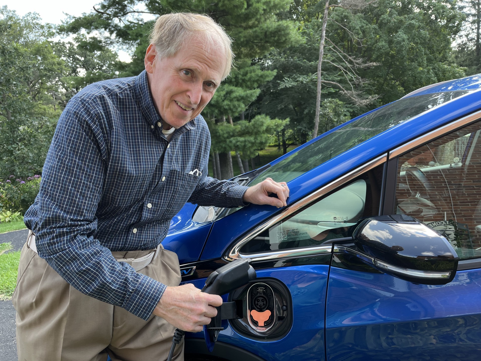 Scott Summers plugging in an american made electric vehicle