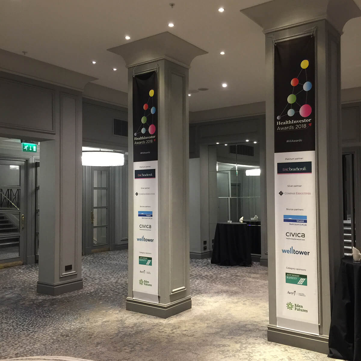 Two large hanging column banners at an Awards event