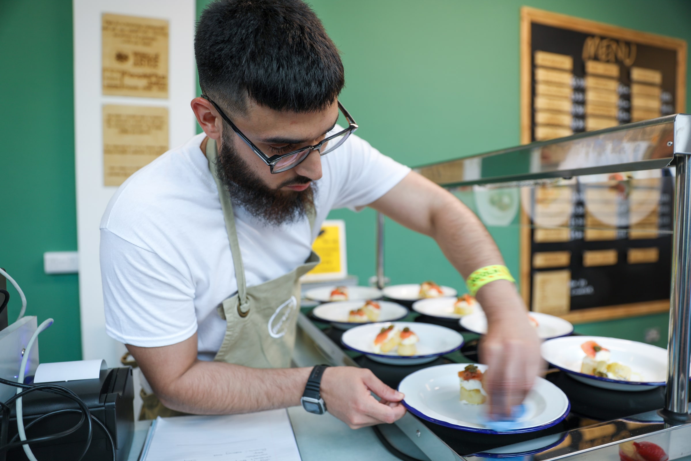 A prisoner puts the finishing touches to some dishes being served in the prison restaurant