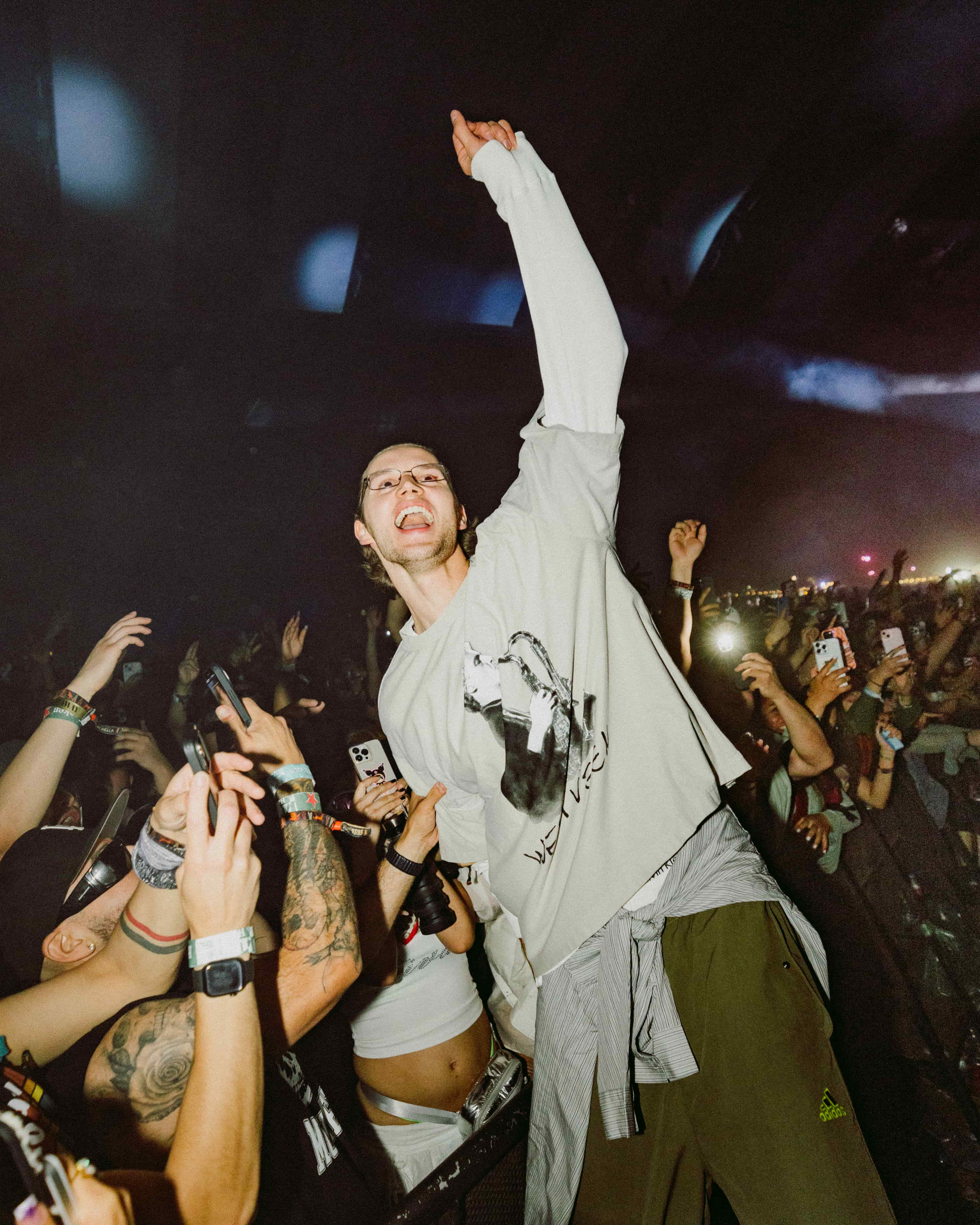 MAU P interacting with fans at Coachella 2025, leaning into the crowd with arm raised as attendees capture the moment, photographed by A World Away creative director Brandon Densley