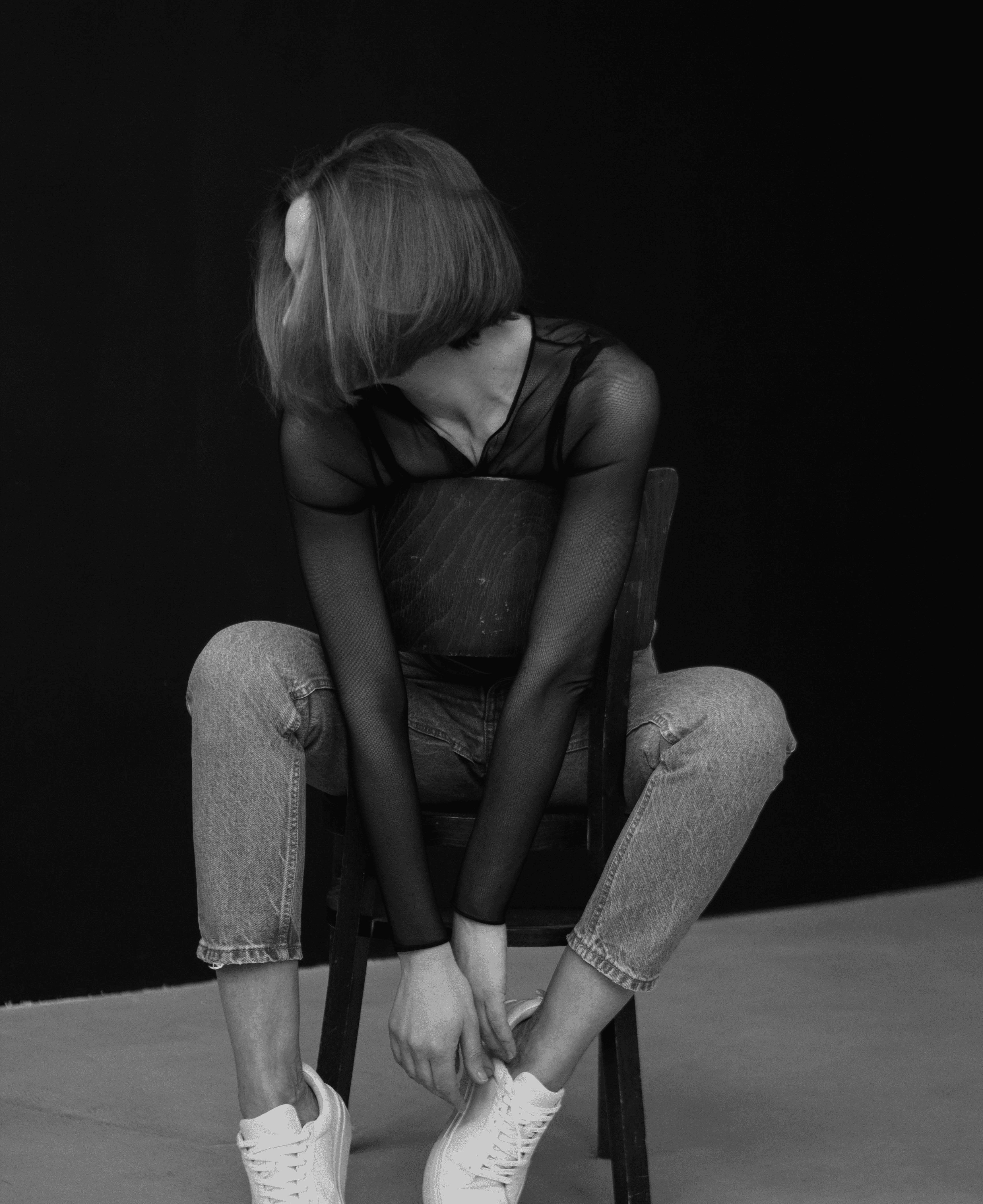 Woman Posing on Chair in Black and White