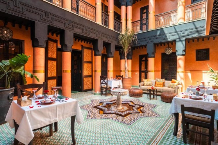 sunloungers fronting buildings near mountain