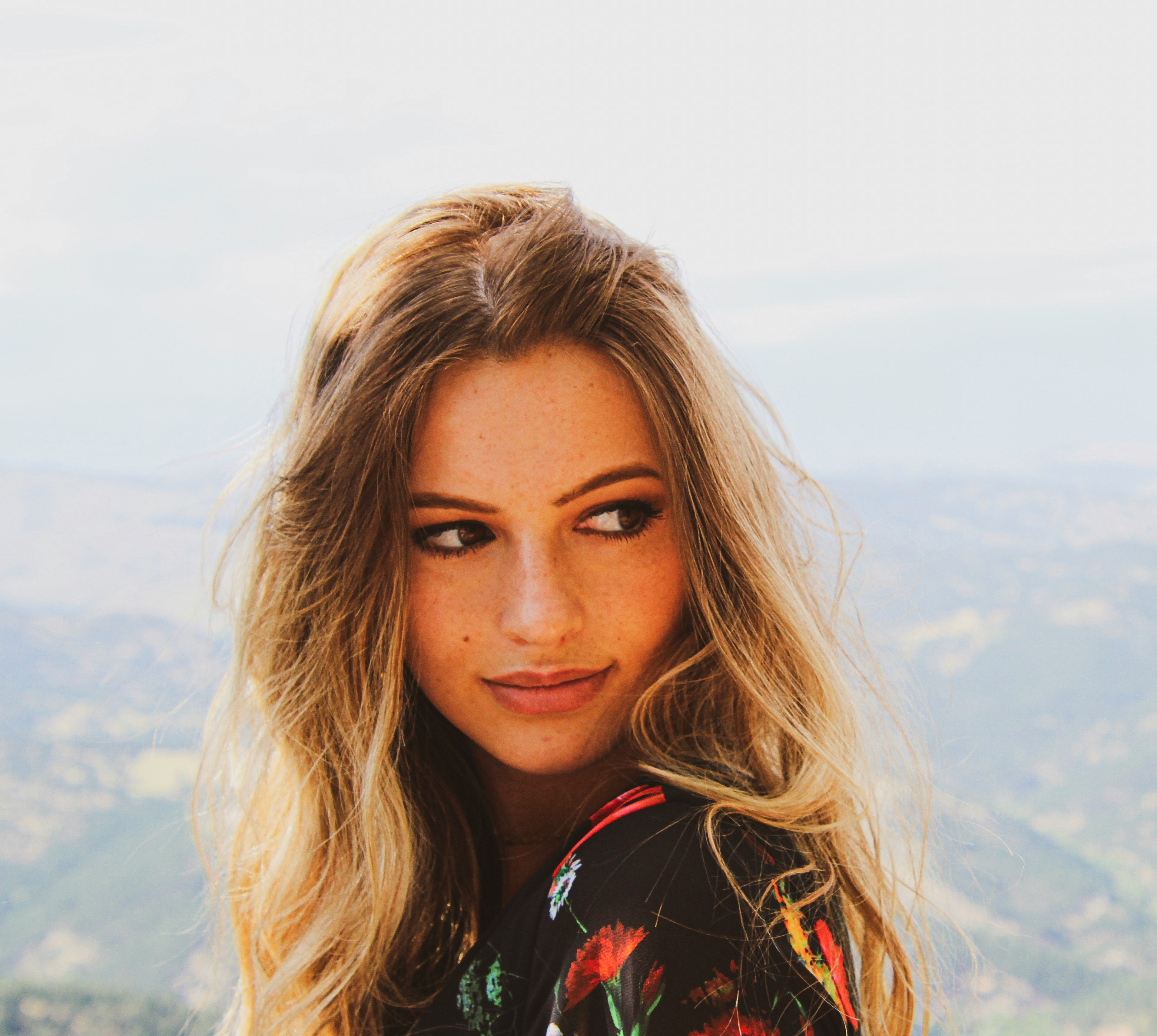 her way agency blonde haired woman with mountain scenery behind her