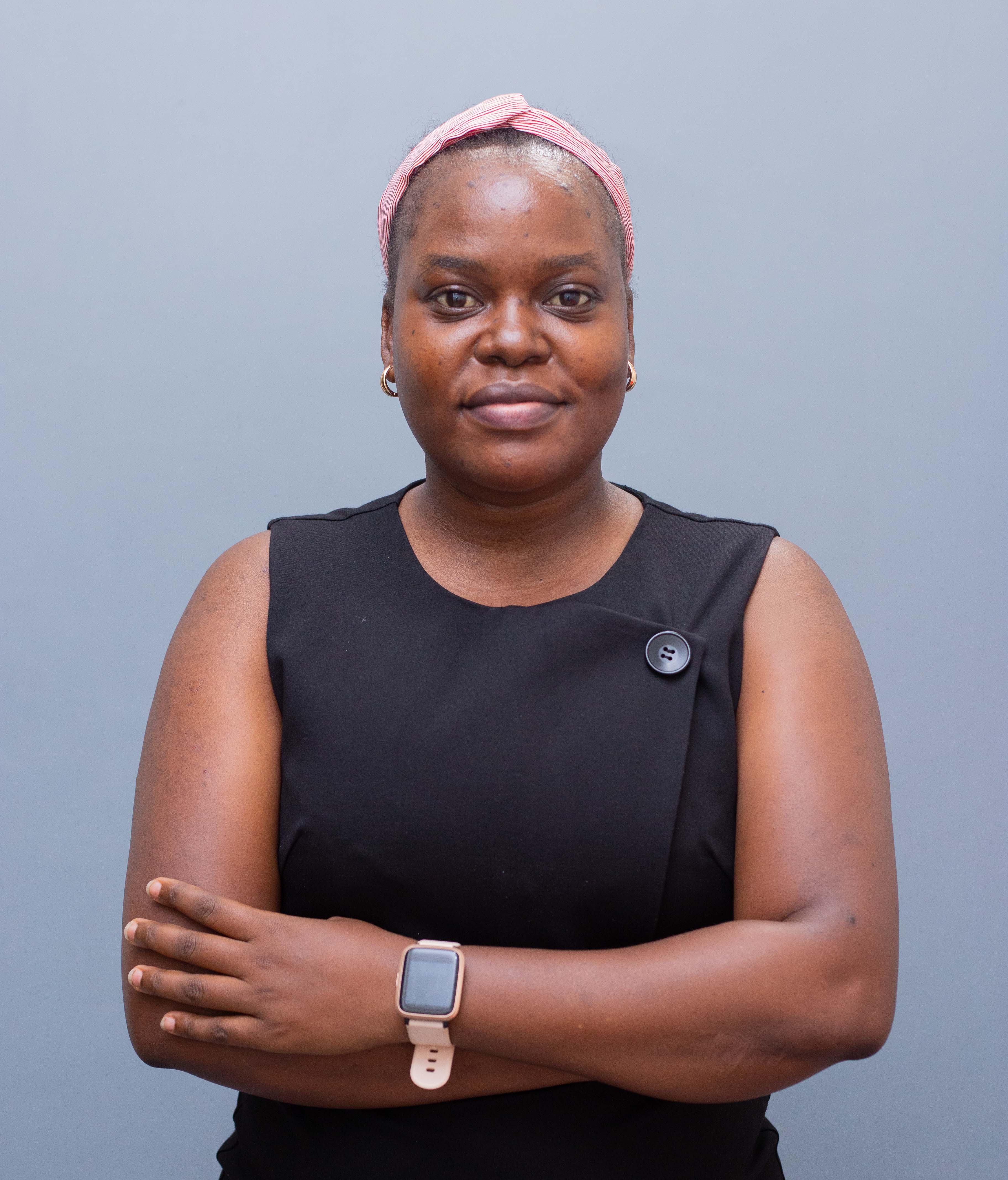 woman in black crew neck t-shirt wearing brown framed eyeglasses standing on rocky shore during