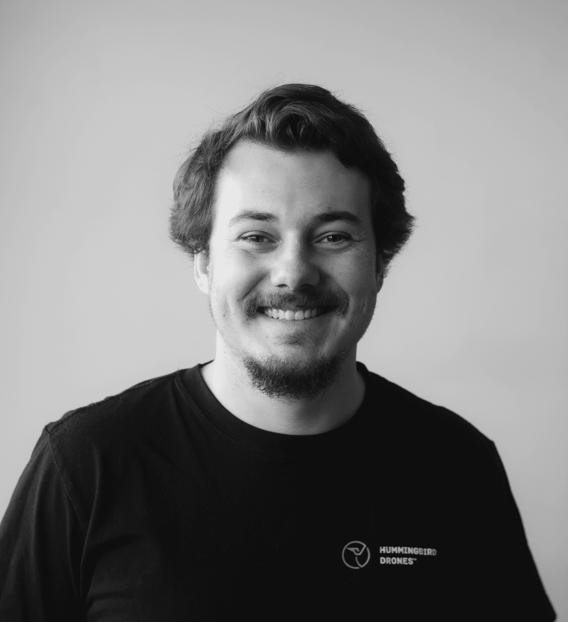 Portrait of Cameron Logan, Mid length hair, big smile friendly and approachable.