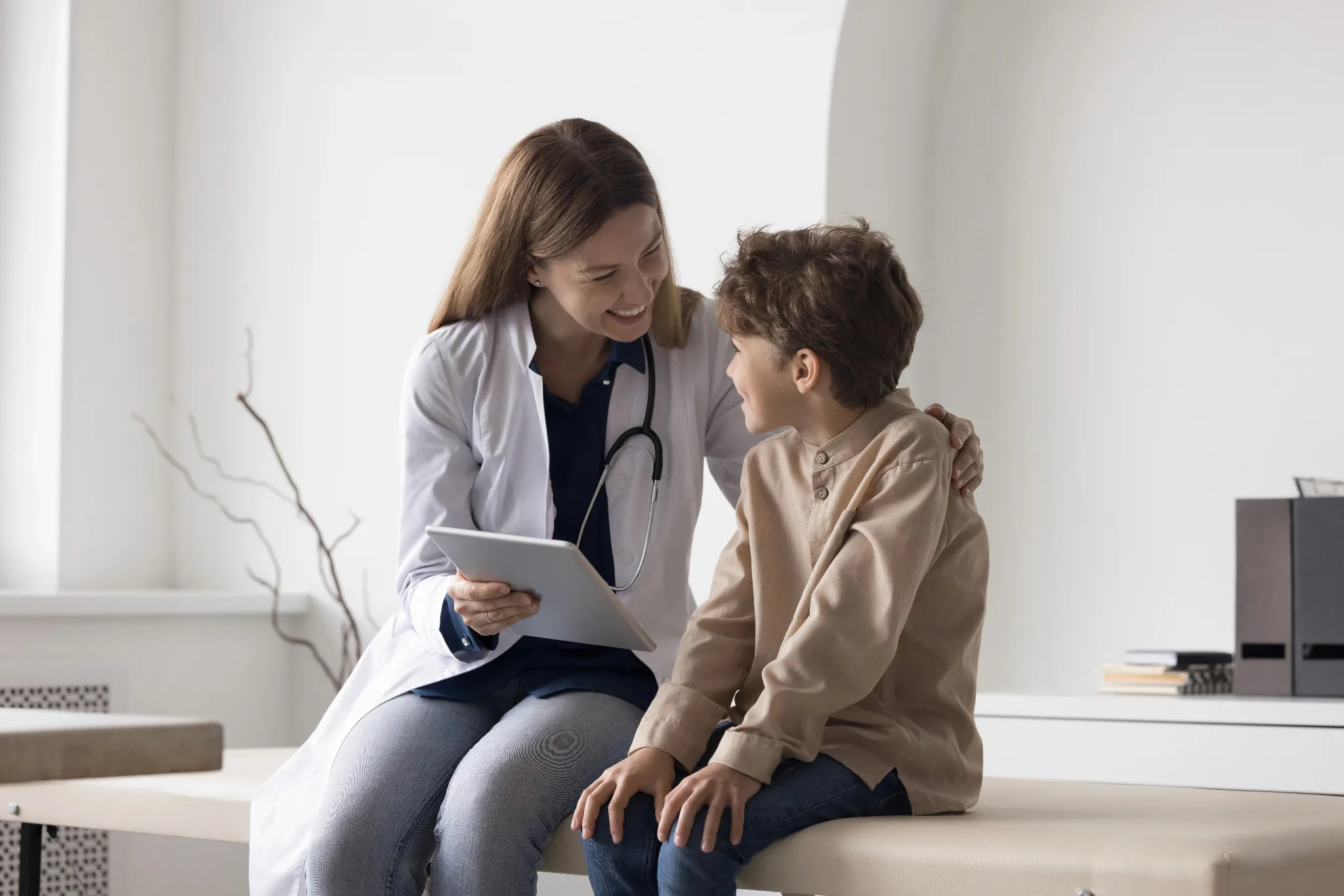 Female physician talkings with a boy.