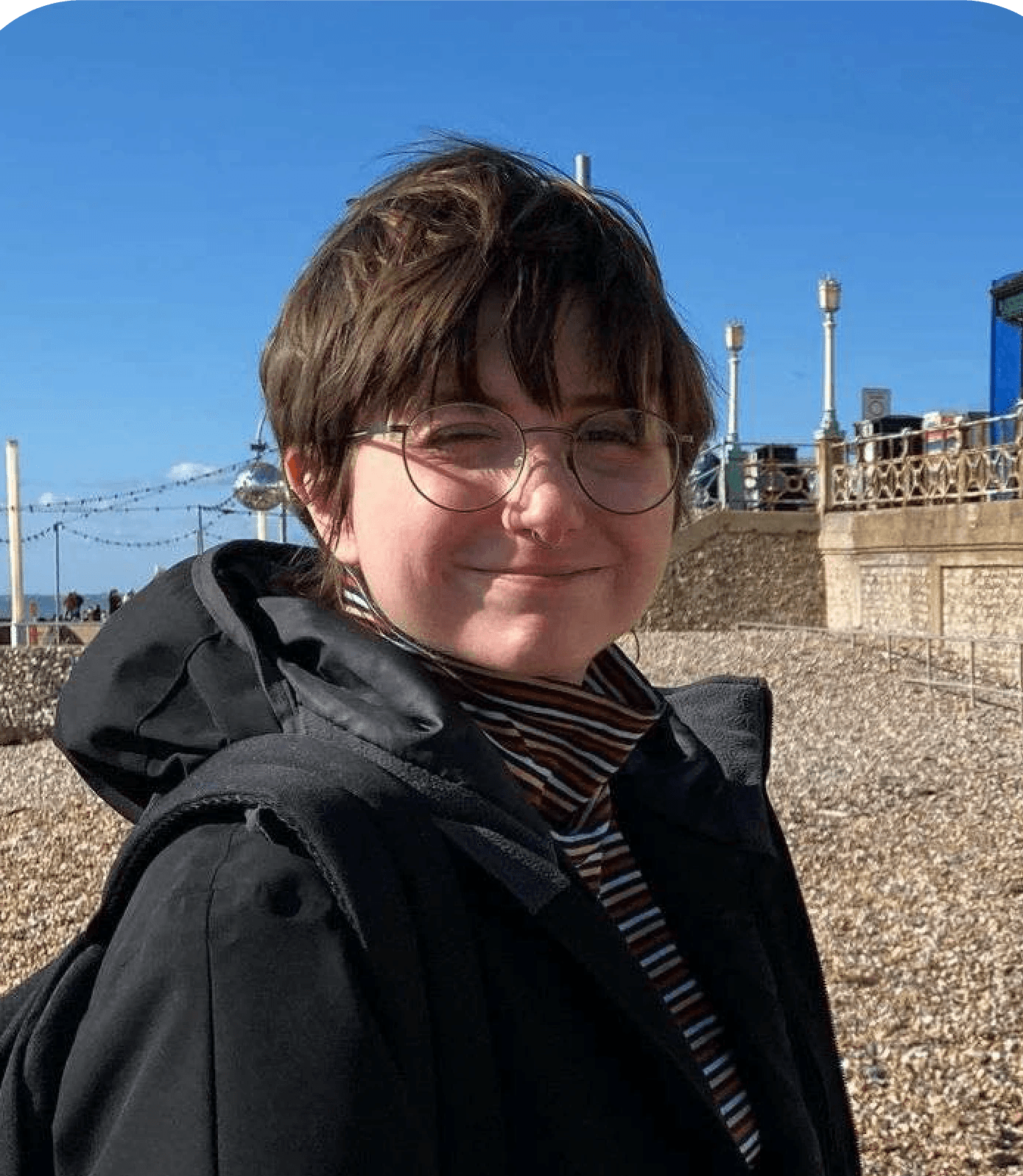 portrait of a young woman smiling face camera, at the beach