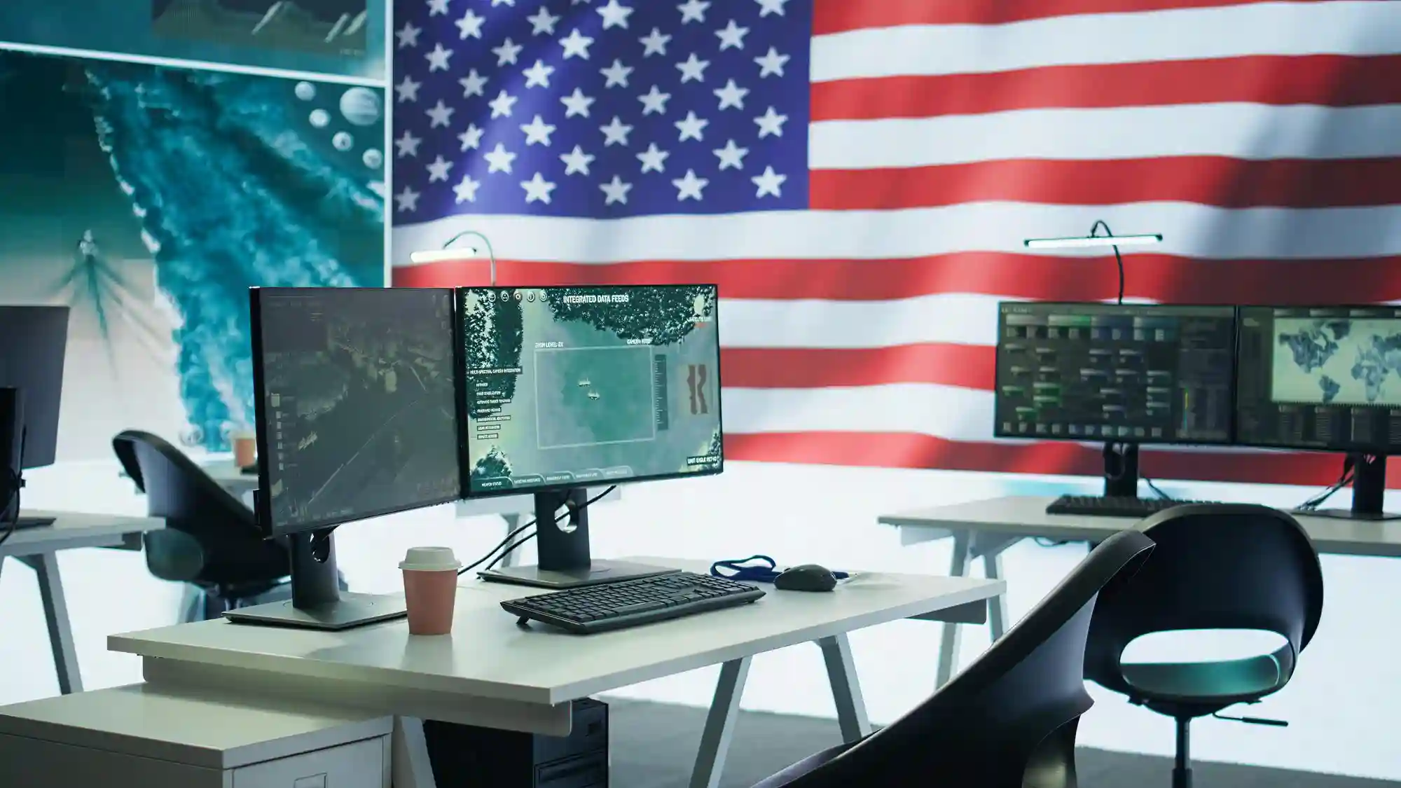 A modern workspace featuring multiple data monitors against a United States flag, symbolizing national advancements in digital infrastructure.