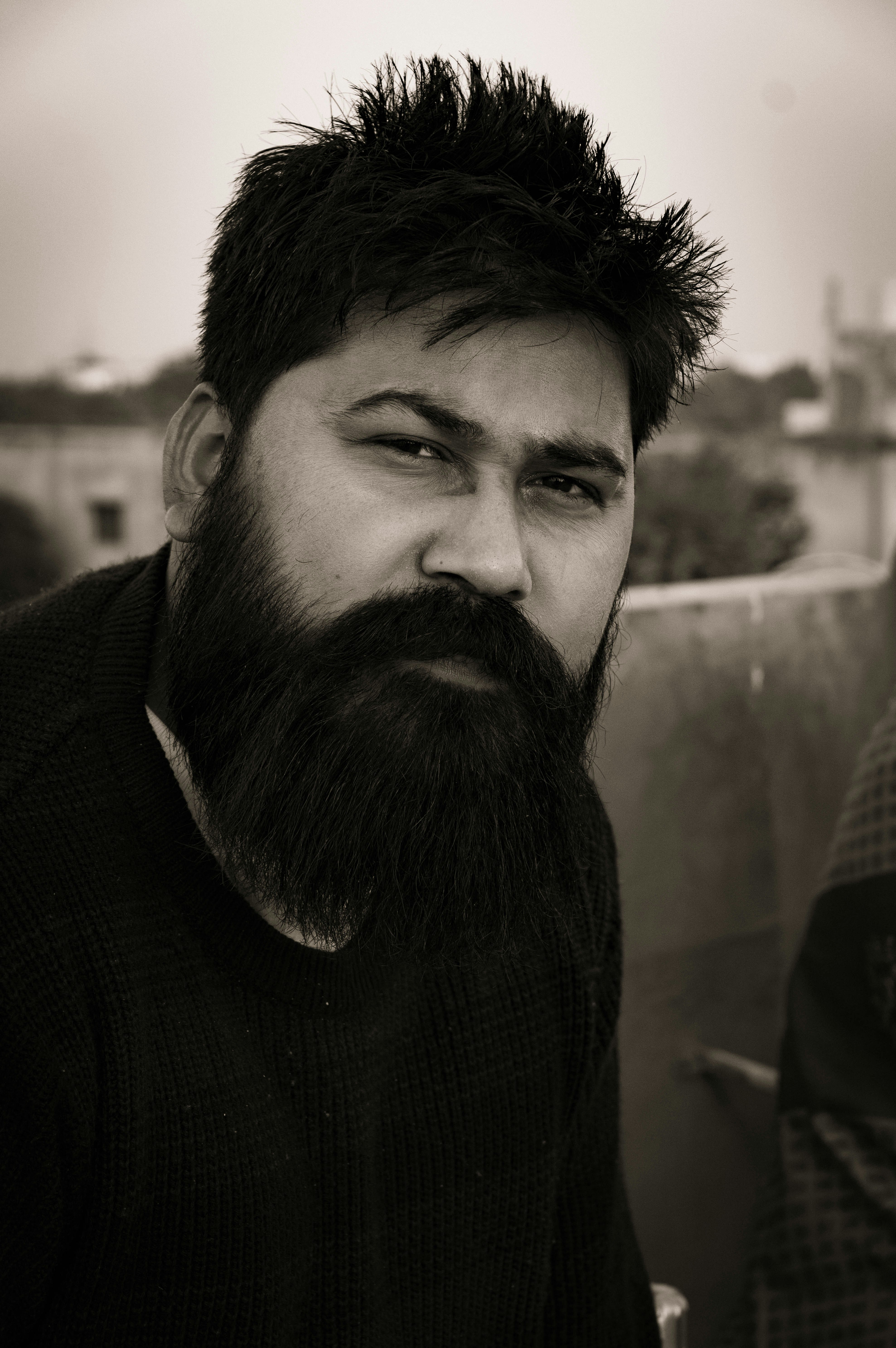 A black and white photo of a man with a beard