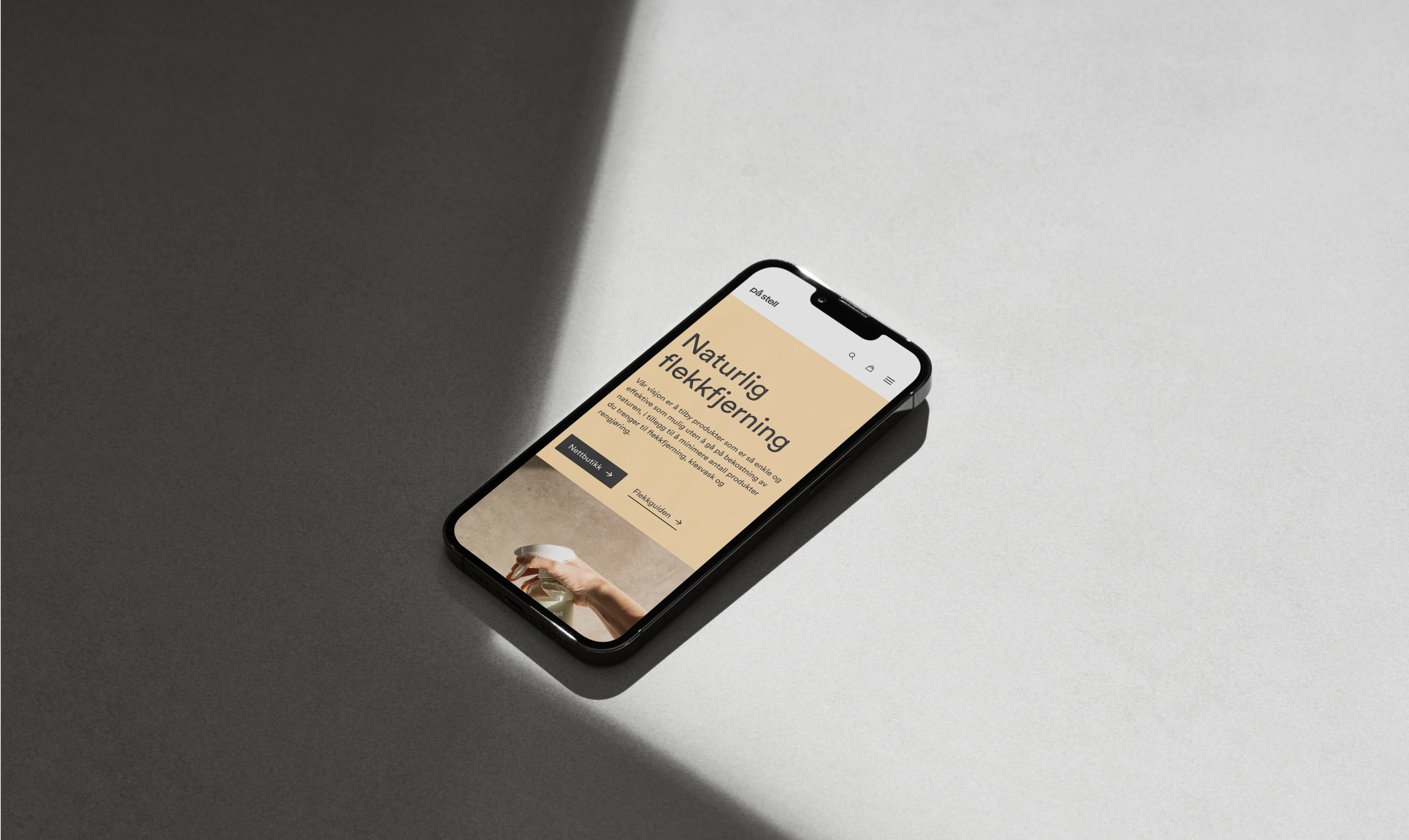 A smartphone with a website displayed on the screen. The website features text in Norwegian with a clean design.