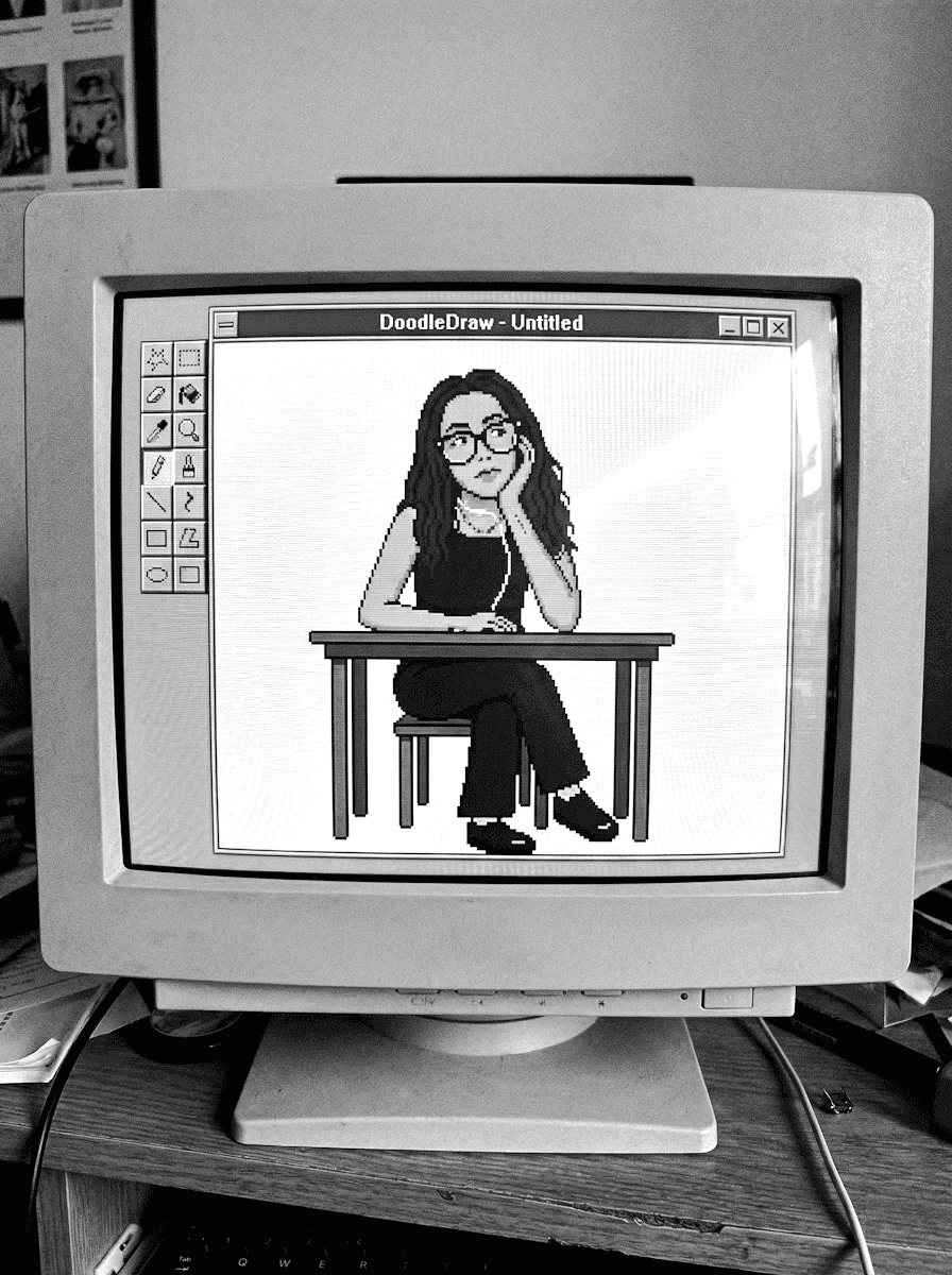 Black-and-white photo of a vintage CRT monitor showing pixel art in a drawing program window.