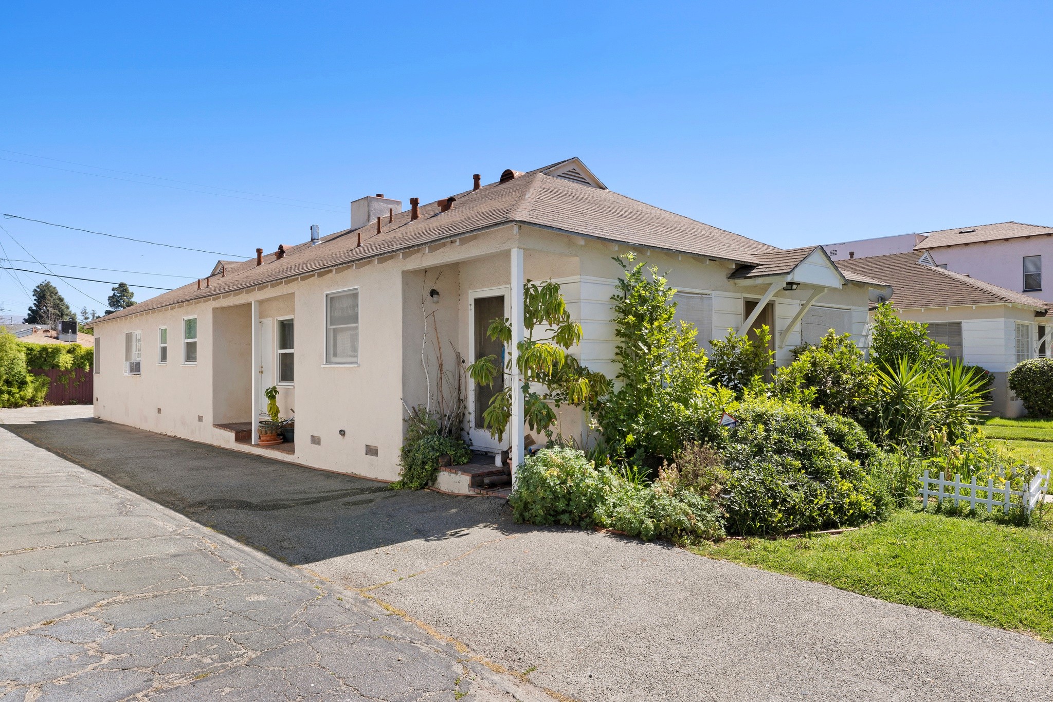 Side view of duplex showing driveway access and building layout at 242 N Cordova Burbank property.