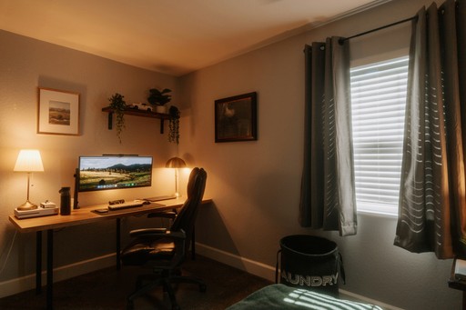 Modern home office with computer and desk.