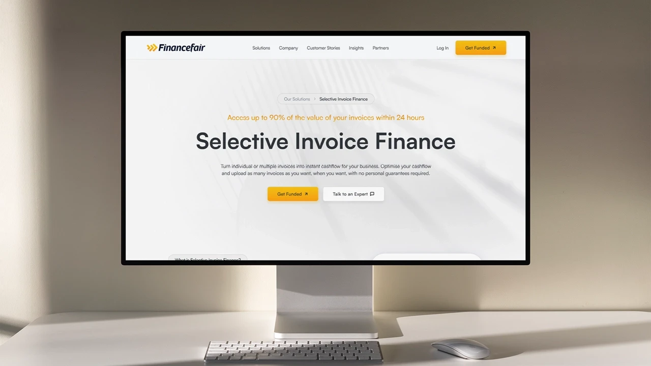 Desktop computer showcasing the FinanceFair website hompage