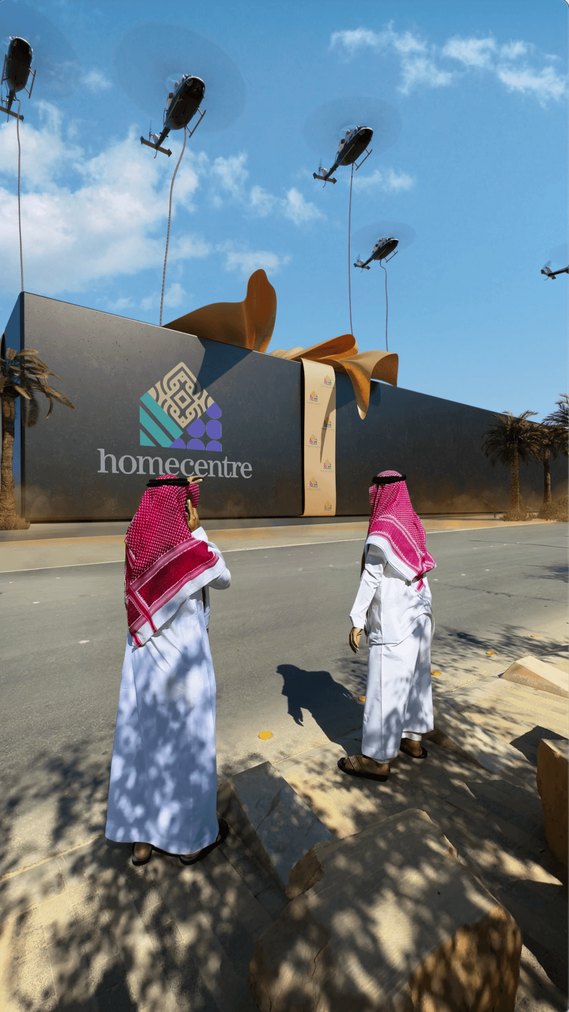 Helicopters lifting a giant "Homecentre" gift box as two men watch from the street