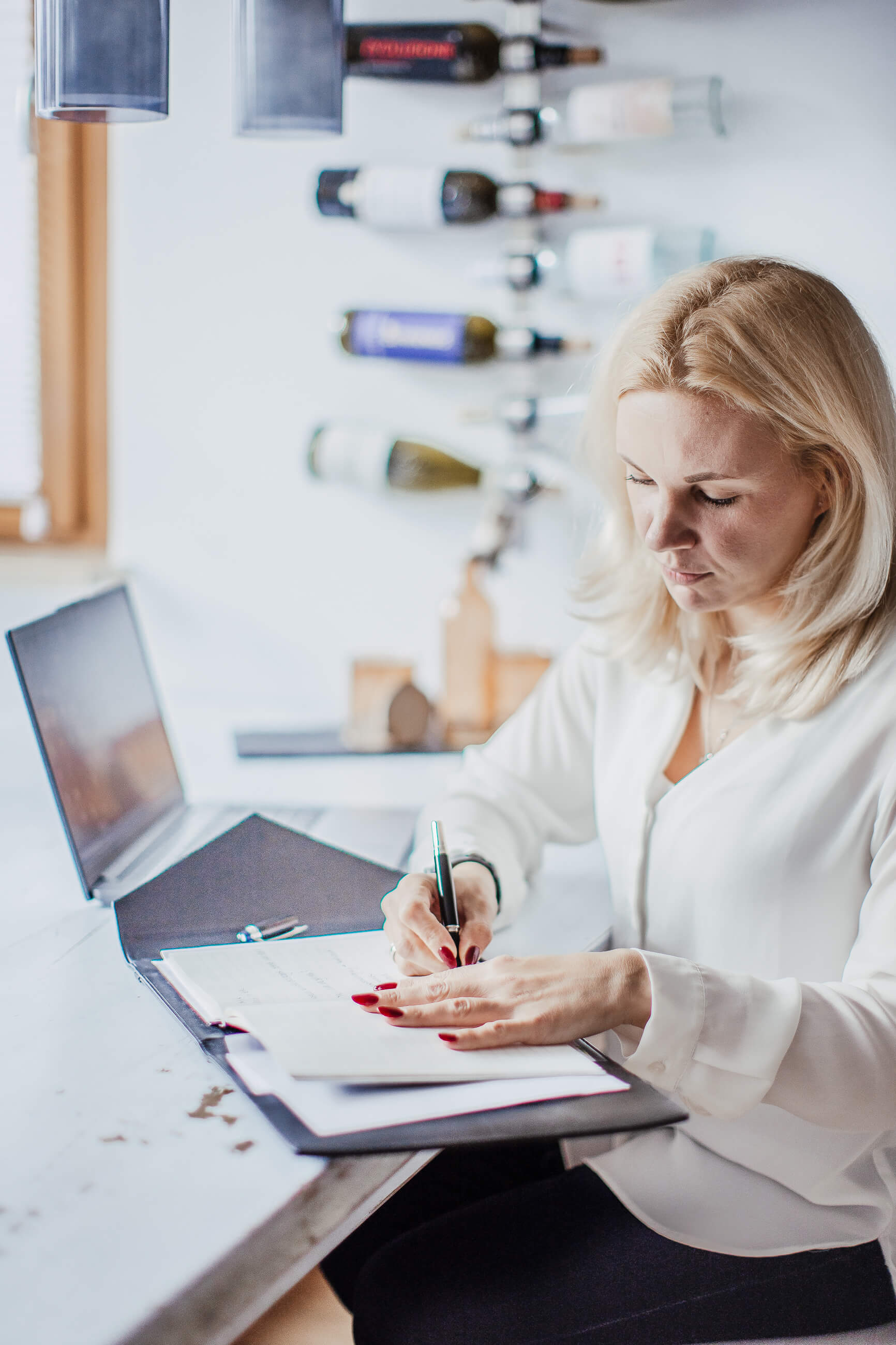 HR-Beraterin überprüft und dokumentiert Employer-Branding-Strategie an ihrem Schreibtisch