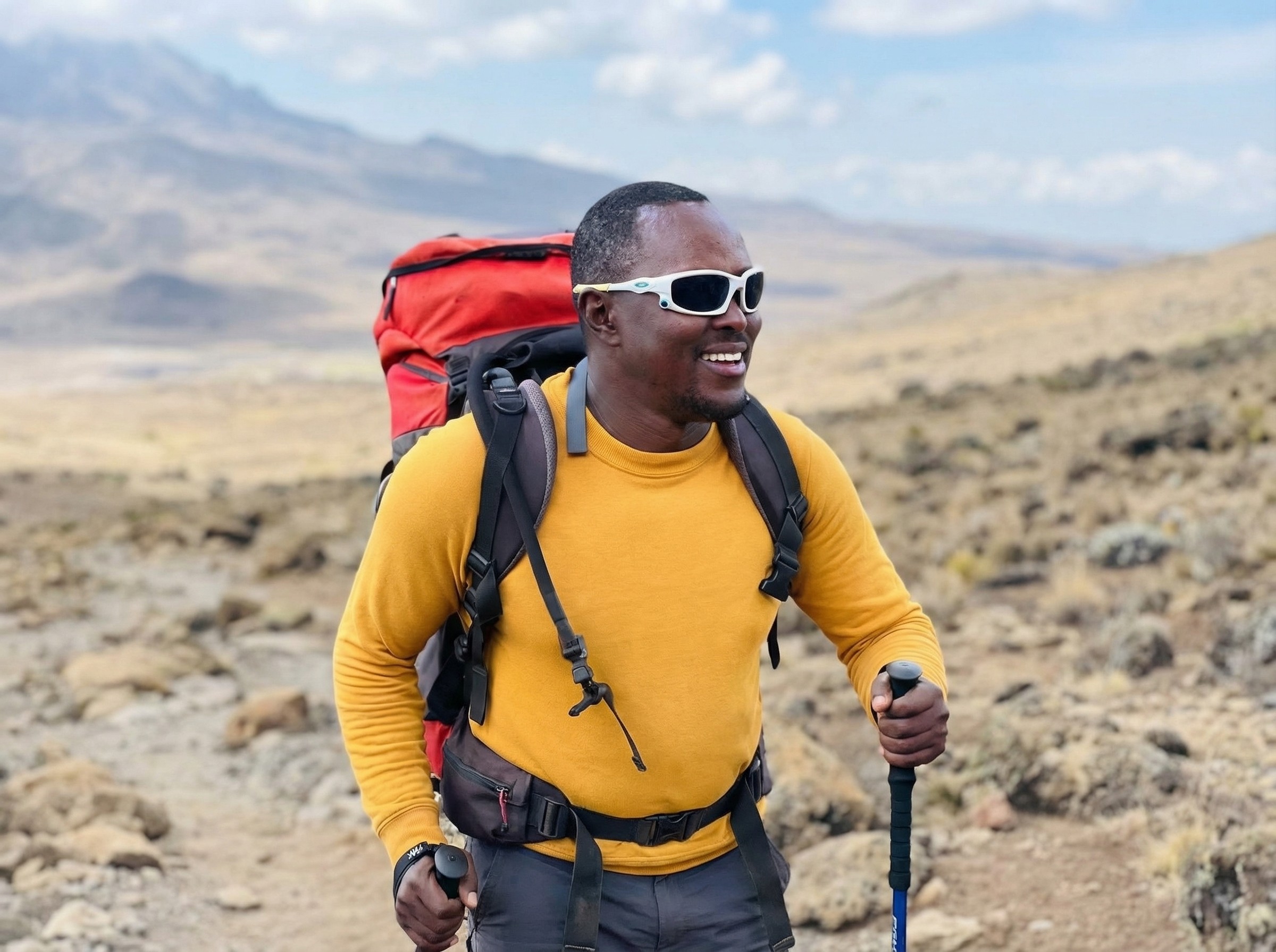 Portrait of Amir Al-Qatifi, founder and lead guide of AlUla desert tours, standing under desert sunlight.