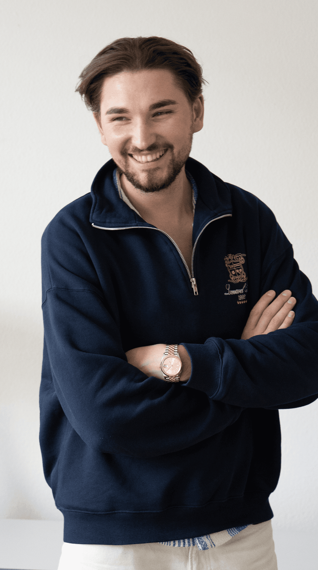 Portrait of a person in a pink sweater against a light background
