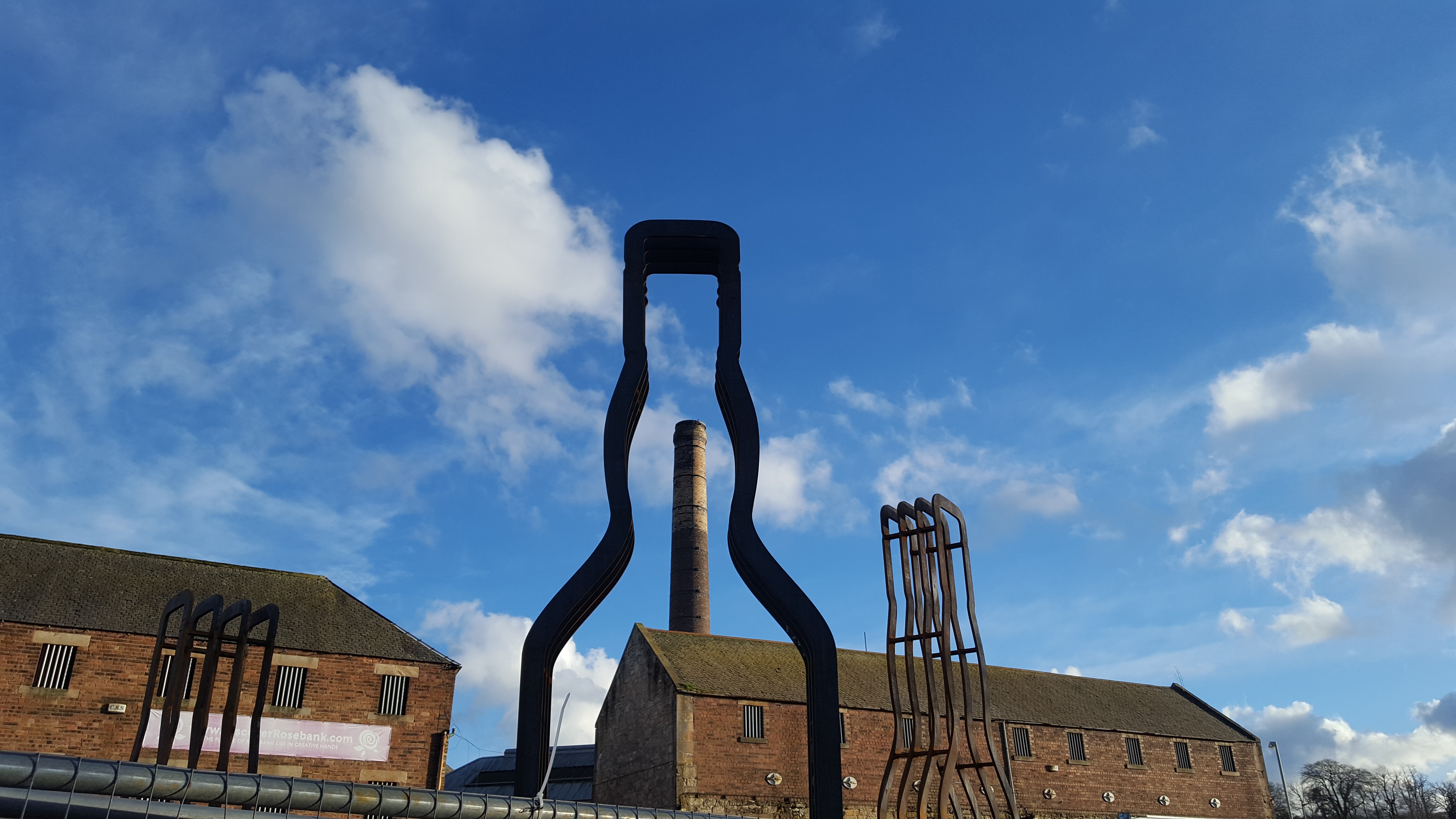 Large-scale outdoor public artwork sculptural whisky installation made from corten steel