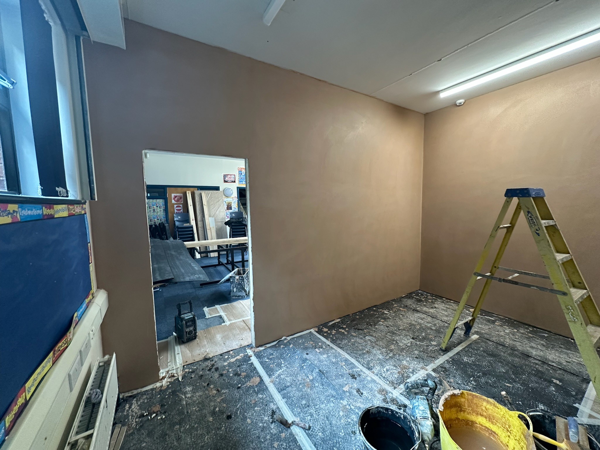 Skimmed new stud walls in high school classrooms.