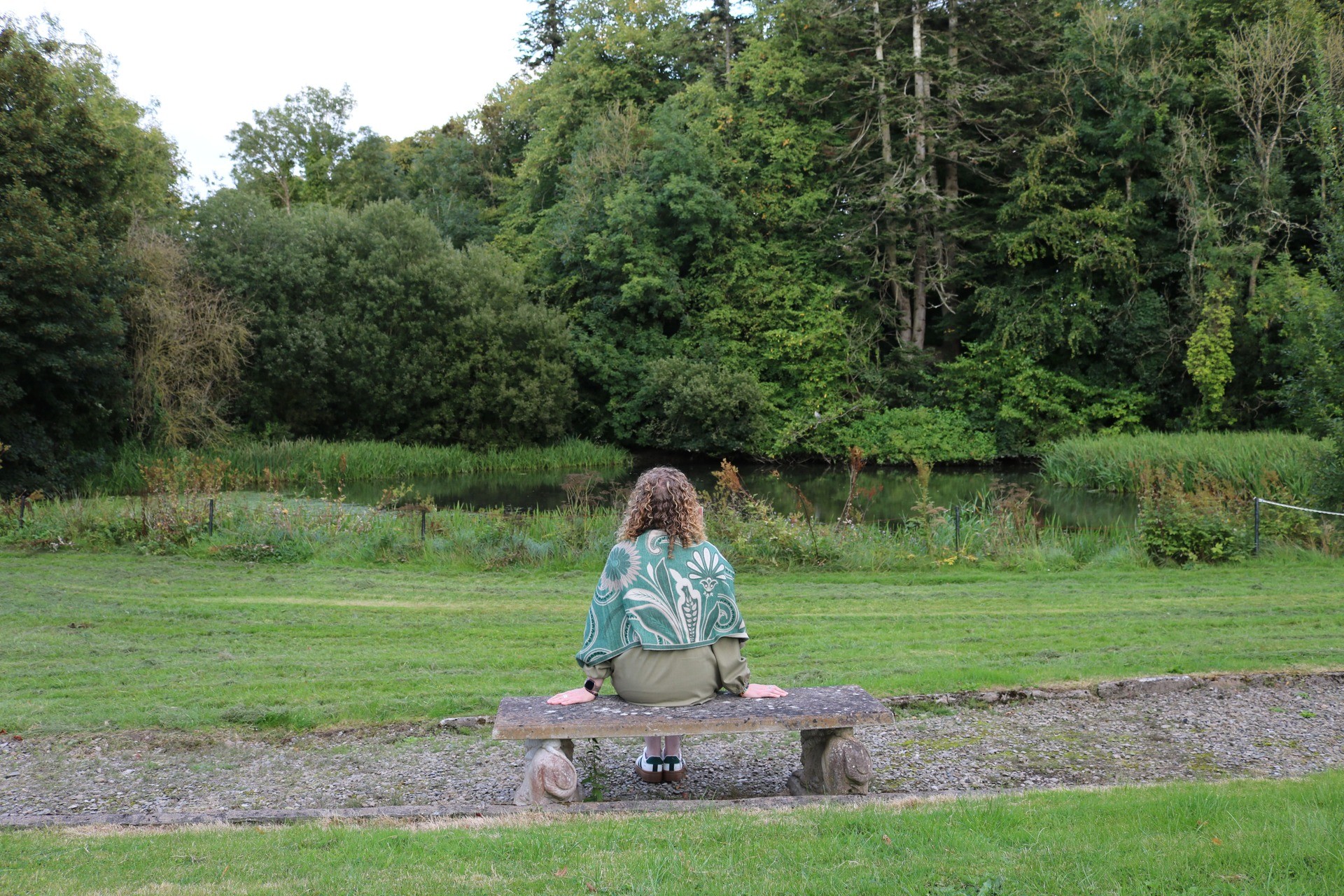 Maryrose meditating perched on stone bench