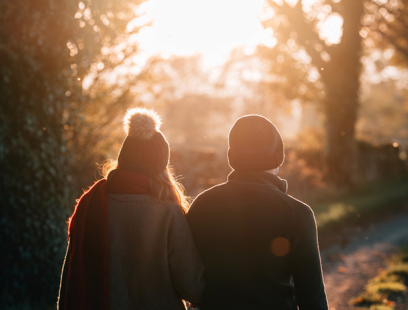 Couple walking in the sunset.
