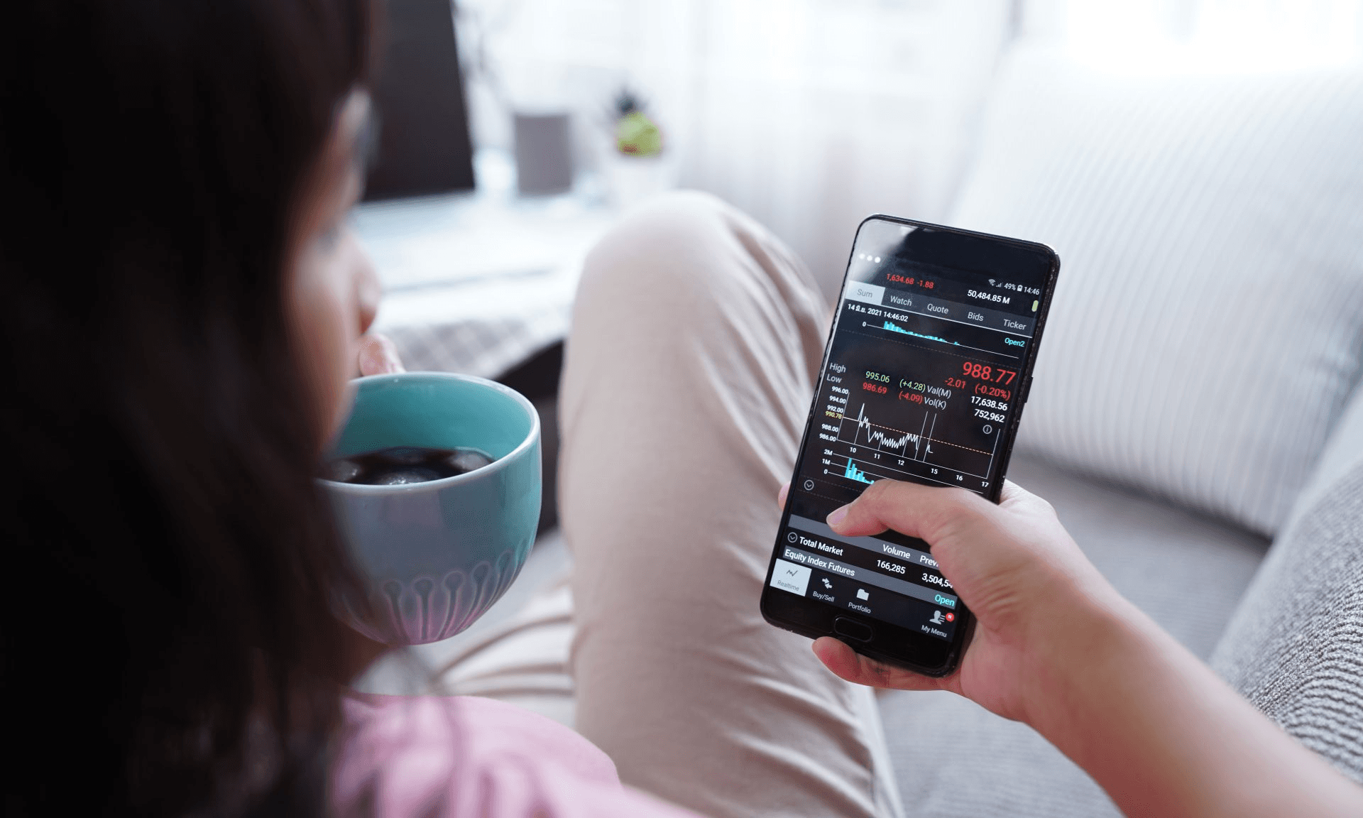 Woman checking stock prices on smartphone - How to Invest in Prediction Markets