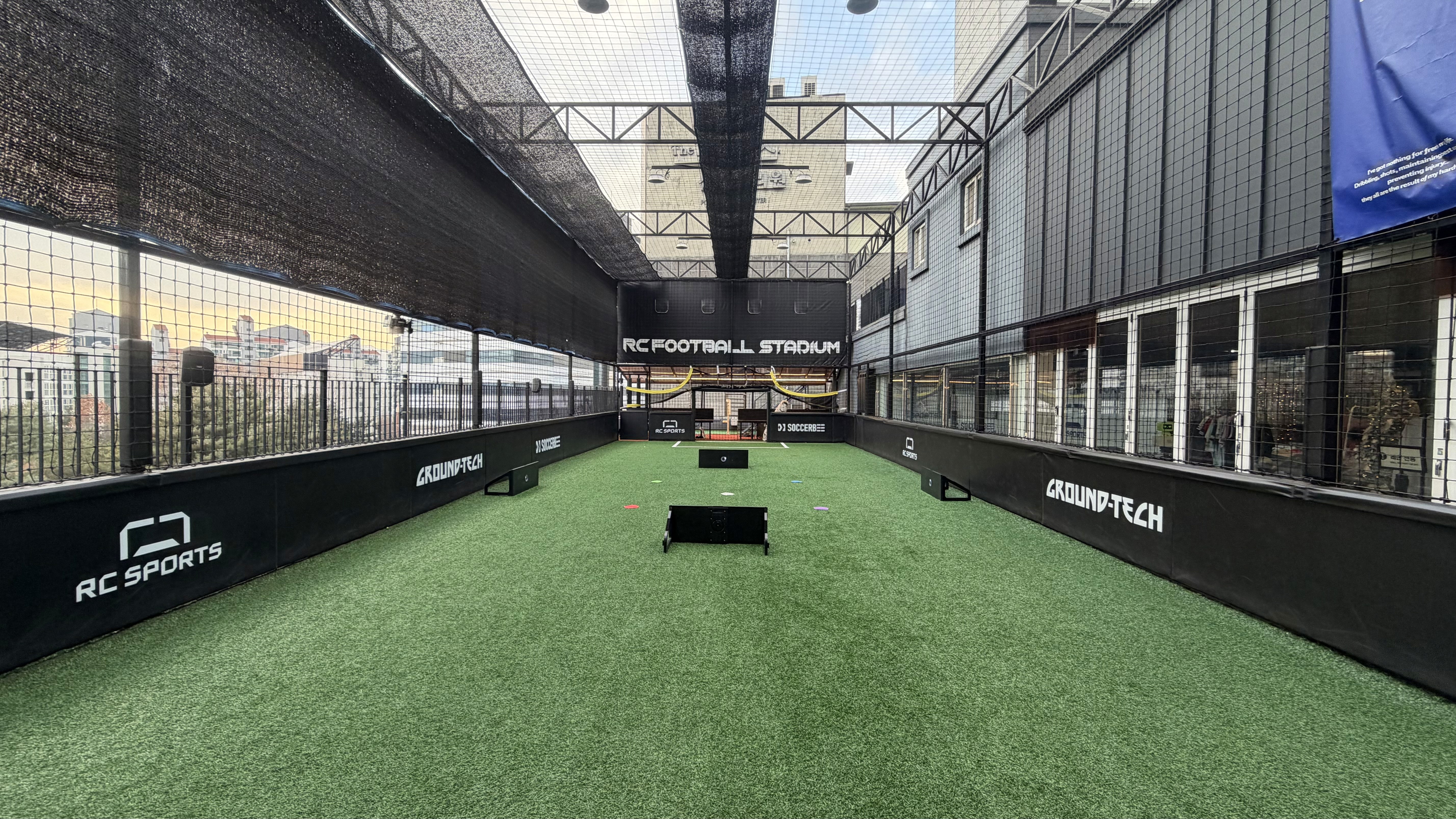 a person's feet with a ball on a purple carpet