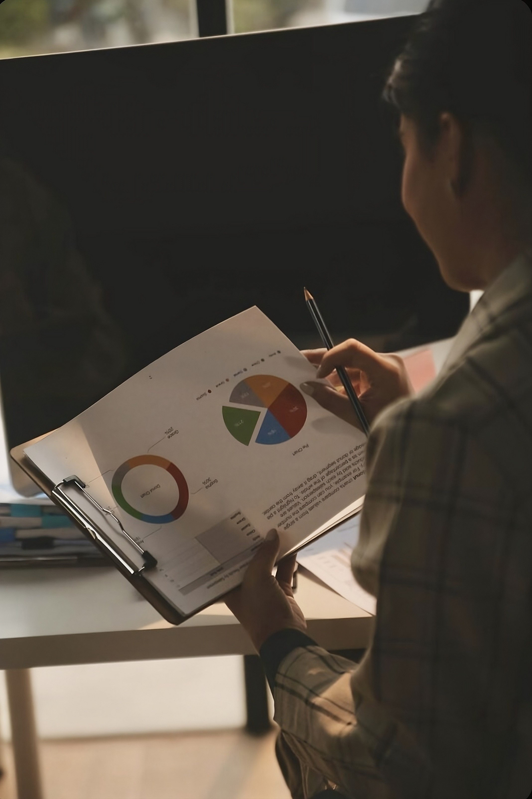 woman sitting around table holding tablet
