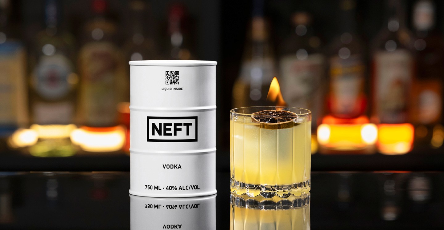 A NEFT Barrel and a glass of My Clementine on a bar counter.