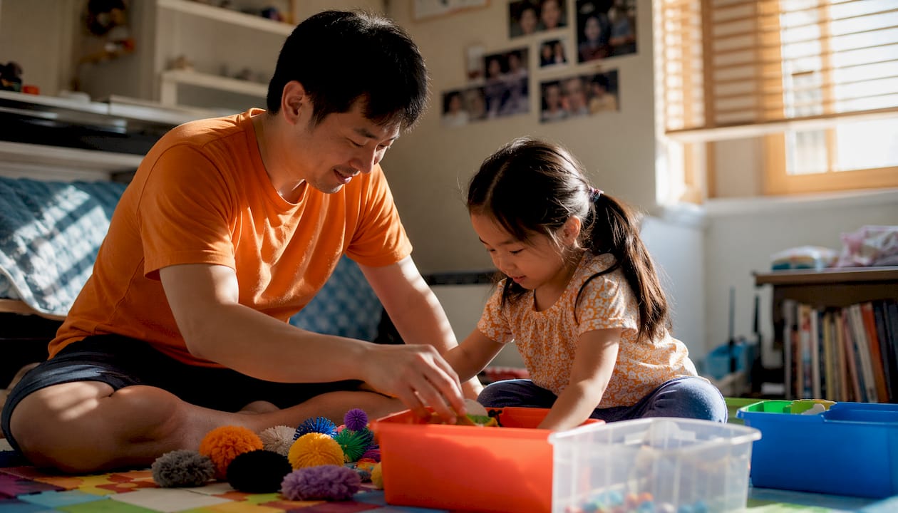 Father organizing sensory toys with daughter