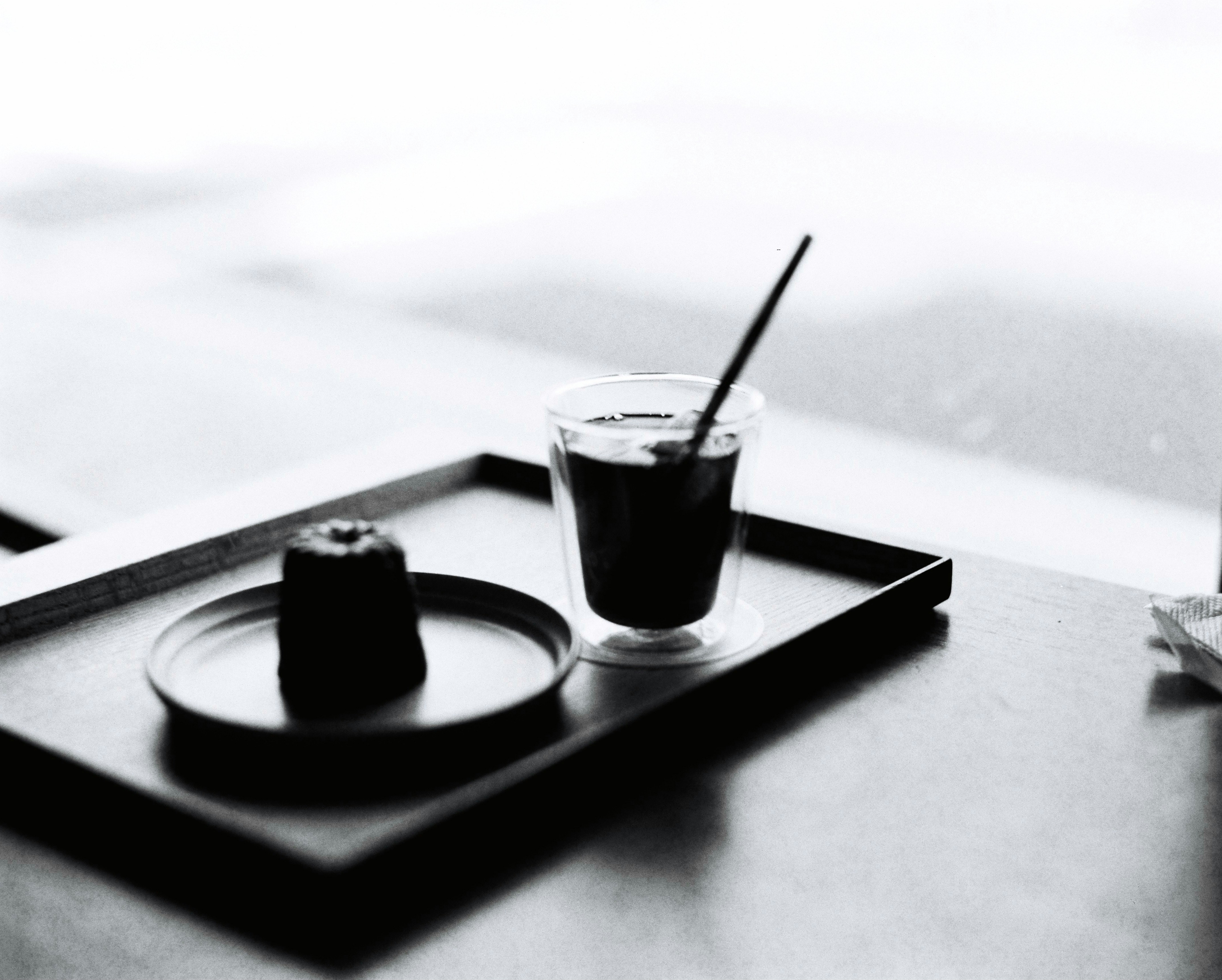 A black and white photo of a tray with a drink on it