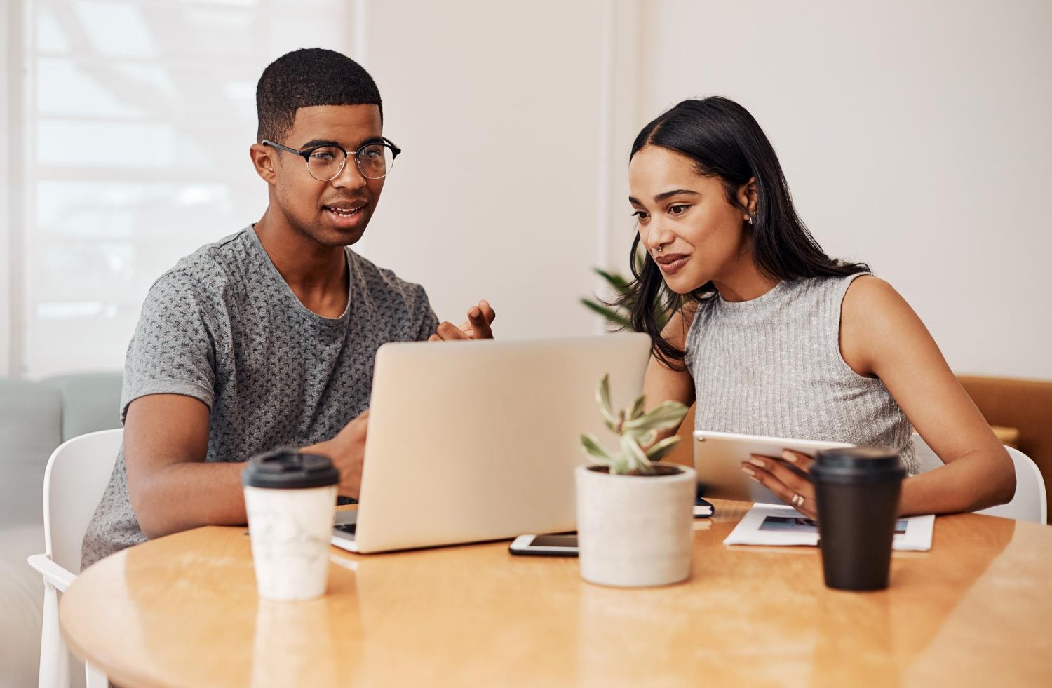 Image of two people staring at computer