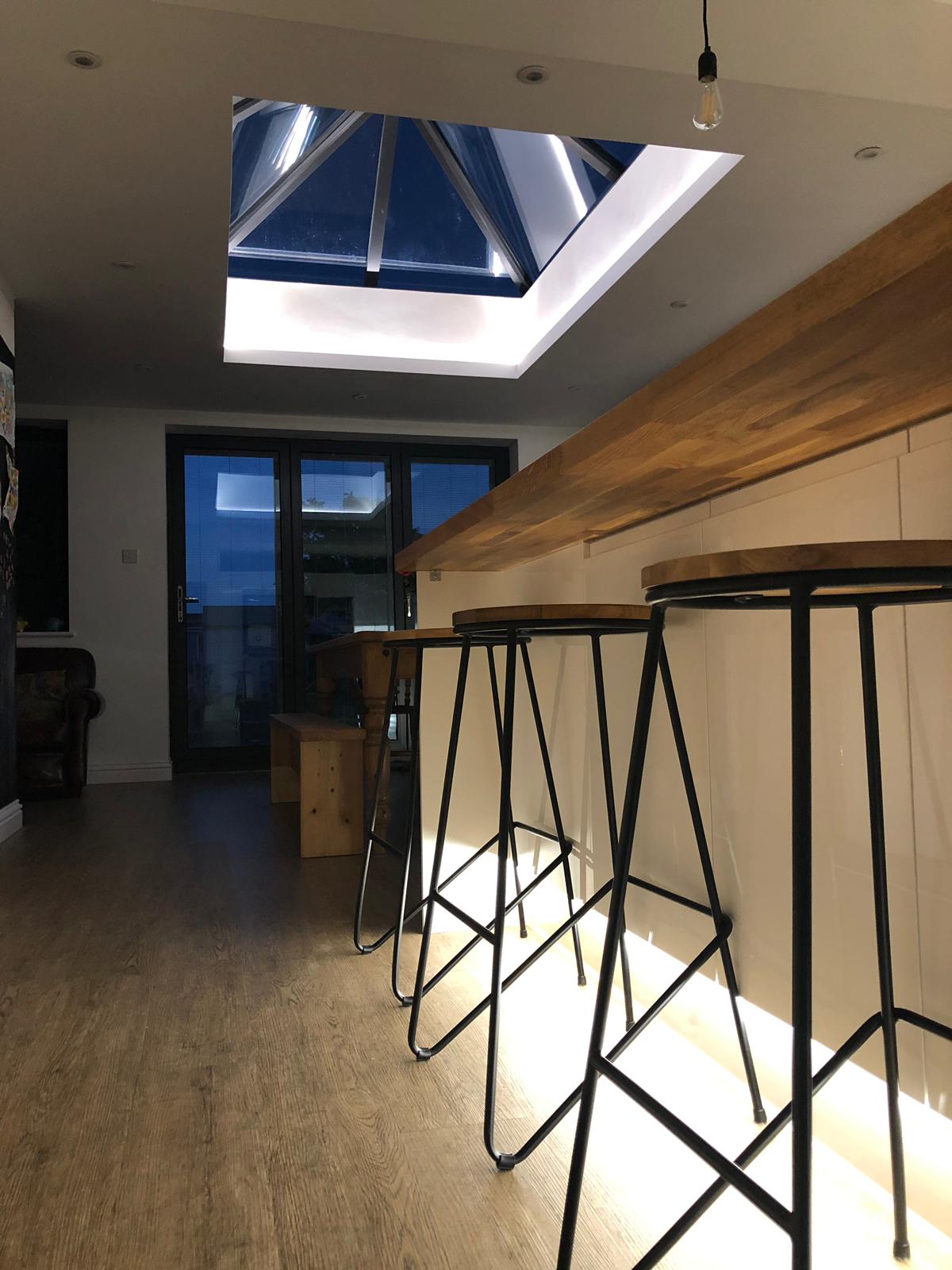 two brown wooden bar stools