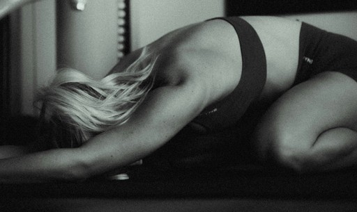 A black and white photo of a woman in lingerie