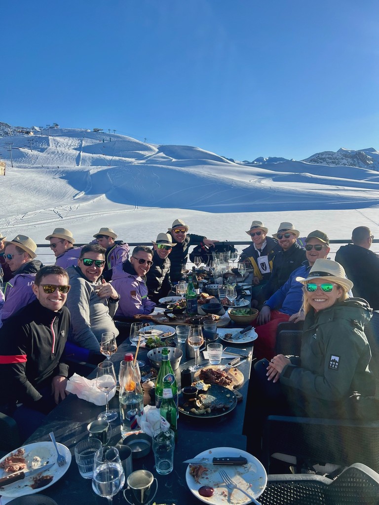 Group photo of IQUW team in front of ski lodge