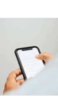 A hand holding a mobile phone