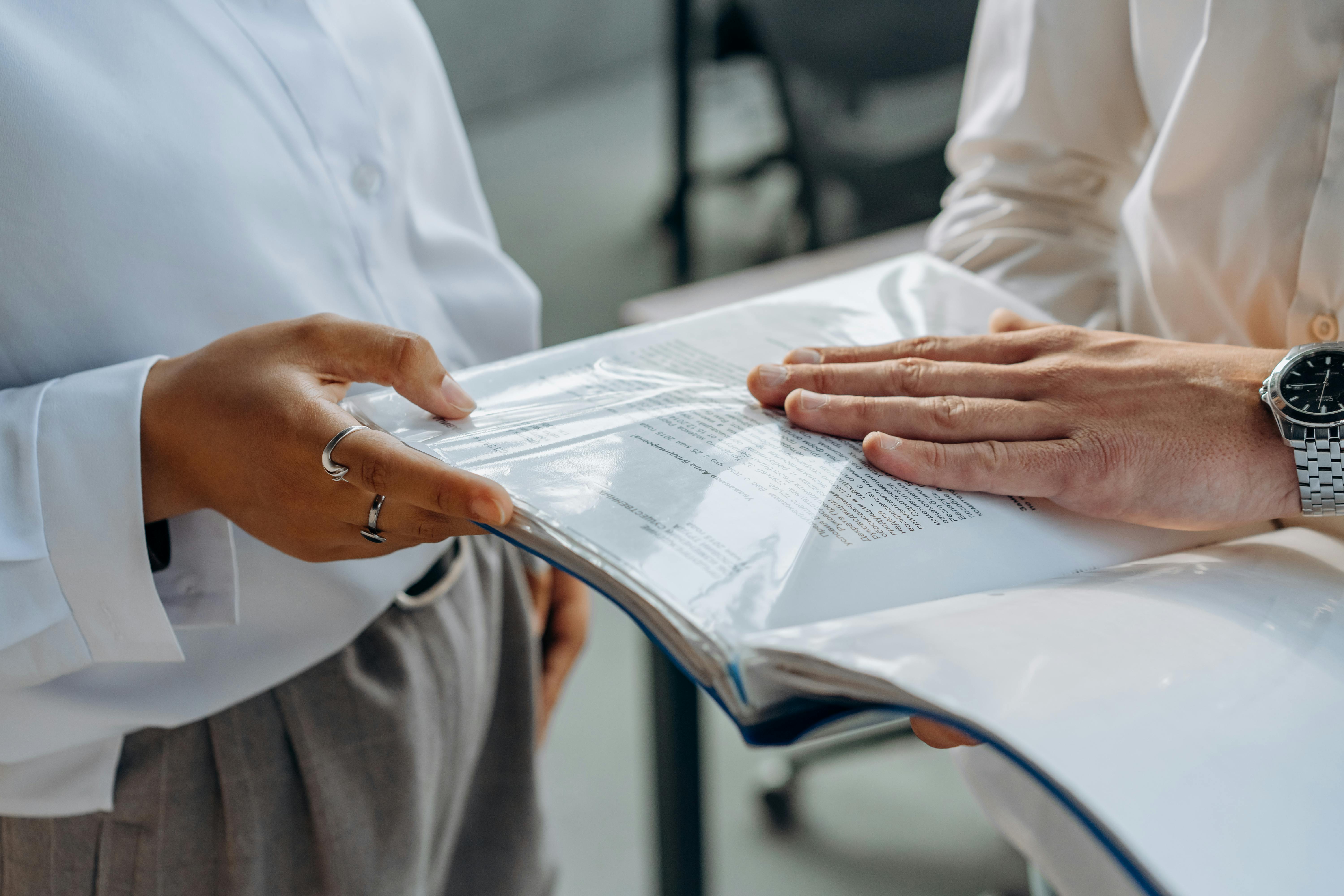 Two professionals reviewing documents together in an office setting