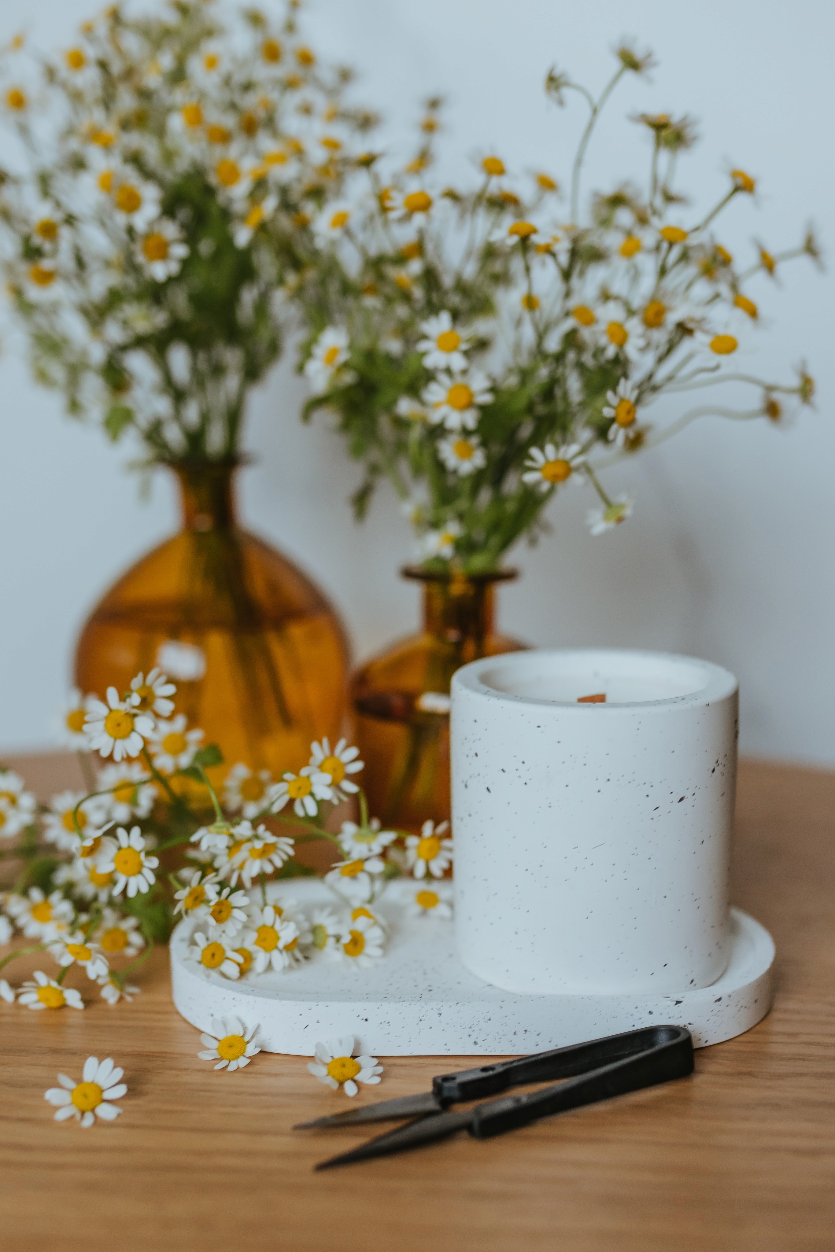 A couple of vases sitting on top of a wooden table.