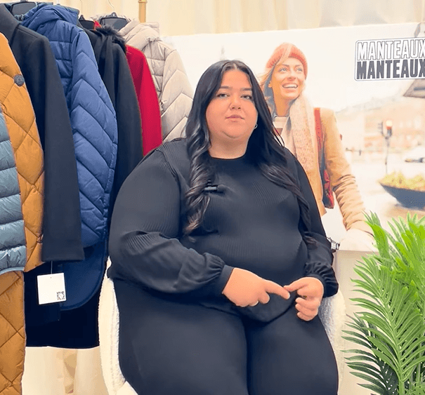 Close-up of lush, dark green leaves, some glossy and wet, against a muted background.