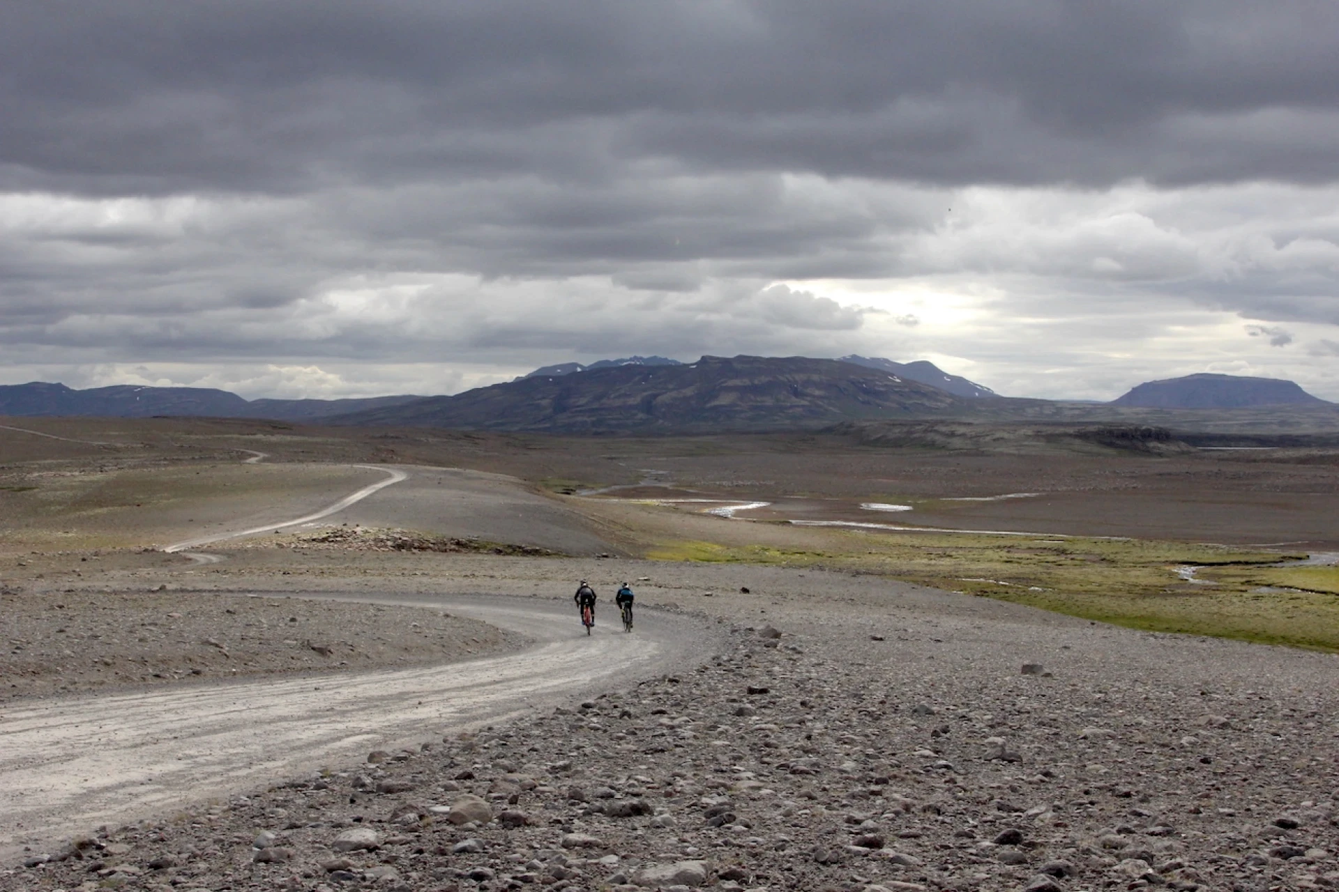 Gravel bike riders in a wide shot of landscape
