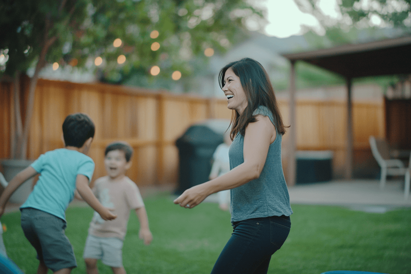 Happy women playing outside with her two children on a summer night