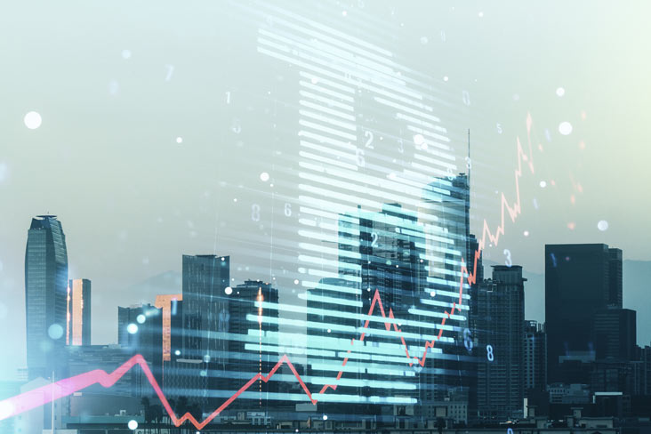 A person walks in front of large stone arches with dark doors, flanked by tall columns, in a historic building.